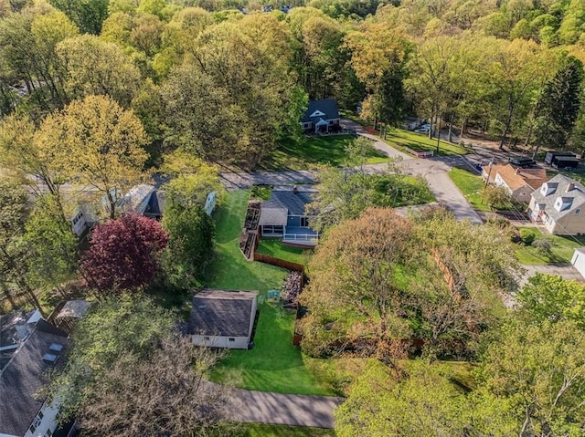 drone / aerial view featuring a wooded view