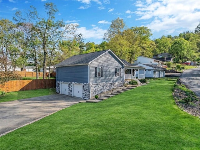 exterior space featuring an attached garage, fence, and driveway