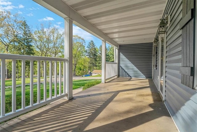 view of patio / terrace with covered porch and a carport