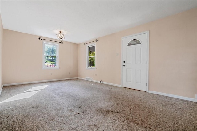 carpeted empty room with baseboards and visible vents