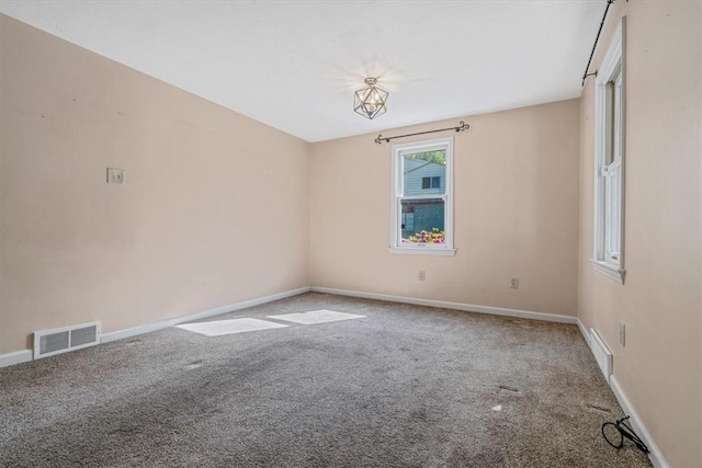 unfurnished room featuring visible vents, baseboards, and carpet floors