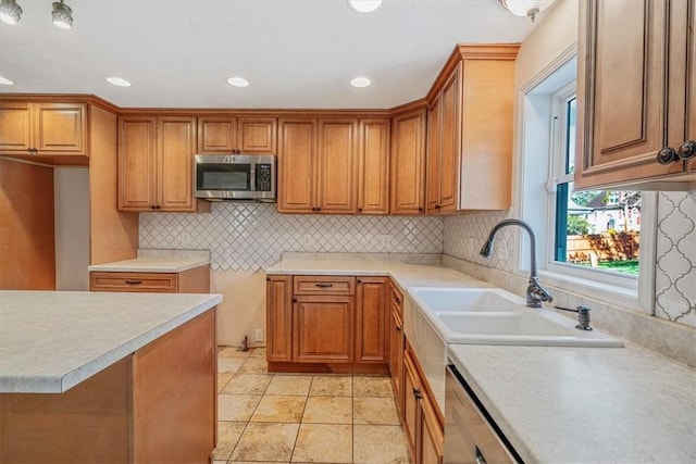 kitchen featuring recessed lighting, tasteful backsplash, brown cabinets, and stainless steel appliances