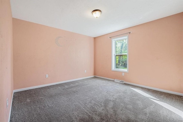 unfurnished room featuring baseboards, carpet flooring, and visible vents