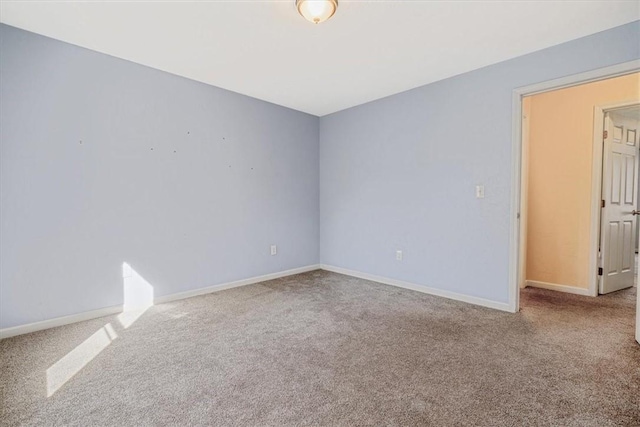 spare room with carpet floors and baseboards