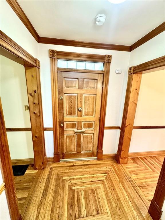 1214 Chislett St, Morningside, PA 15206 - entryway with baseboards, ornamental molding, and parquet flooring