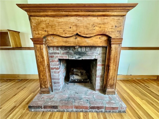 1214 Chislett St, Morningside, PA 15206 - details with a fireplace with raised hearth, baseboards, and wood finished floors