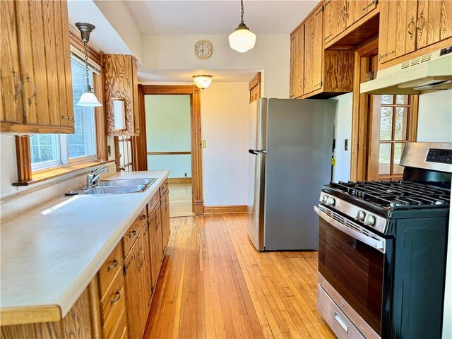 1214 Chislett St, Morningside, PA 15206 - kitchen with a sink, light wood-style floors, light countertops, stainless steel appliances, and under cabinet range hood