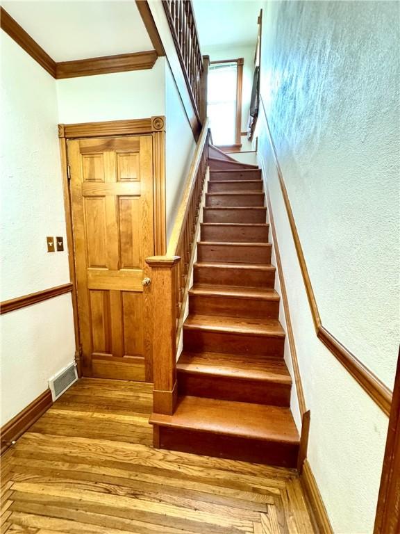 1214 Chislett St, Morningside, PA 15206 - stairway featuring ornamental molding and wood finished floors
