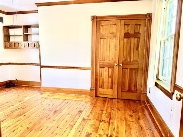 1214 Chislett St, Morningside, PA 15206 - empty room featuring wood-type flooring, baseboards, crown molding, and a wealth of natural light