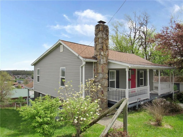 776 W Vine St, Mount Pleasant Boro, PA 15666 - view of property exterior featuring covered porch, a chimney, and roof with shingles
