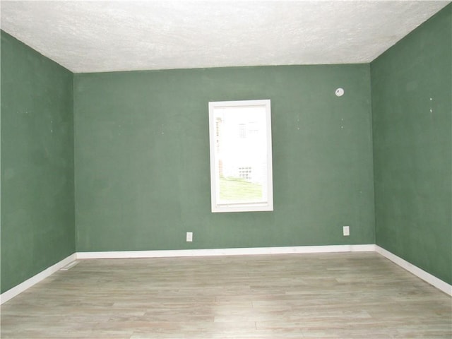 776 W Vine St, Mount Pleasant Boro, PA 15666 - empty room featuring baseboards, a textured ceiling, and wood finished floors