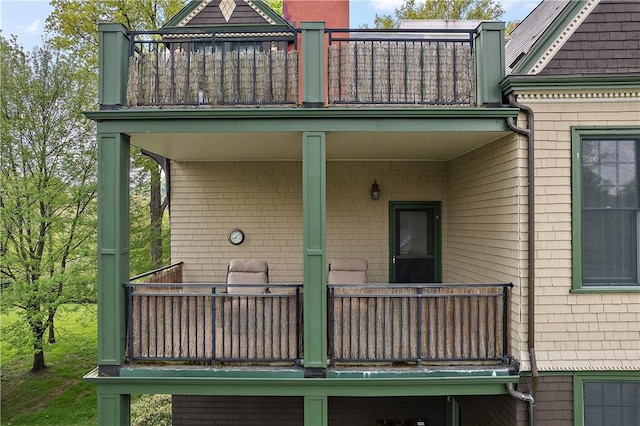 rear view of property featuring a balcony