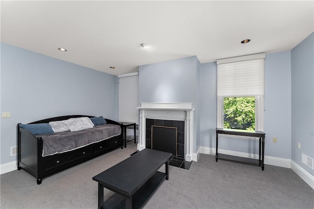 living area featuring visible vents, a fireplace, baseboards, carpet flooring, and recessed lighting