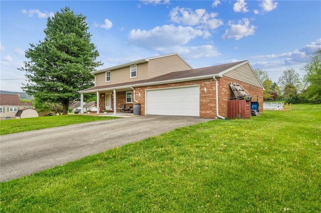 traditional-style house with an attached garage, brick siding, a front yard, covered porch, and driveway