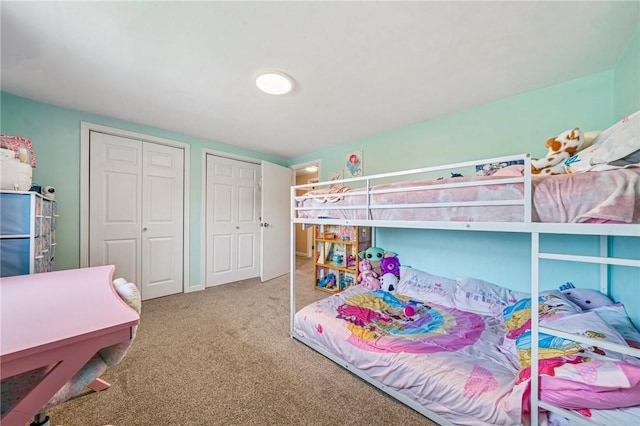 carpeted bedroom featuring multiple closets