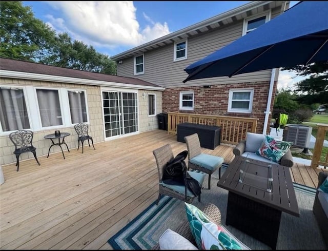 deck featuring cooling unit and an outdoor hangout area