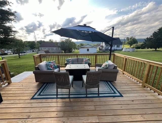 wooden terrace with a lawn and outdoor lounge area