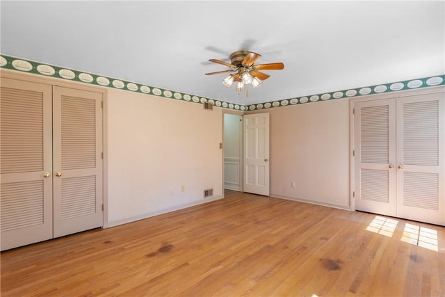 2650 Quail Hill Dr, Upper St Clair, PA 15241 - unfurnished bedroom featuring wood finished floors, baseboards, and two closets