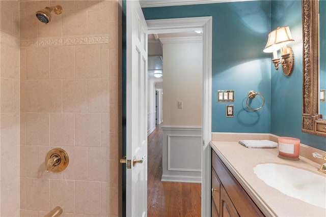 2650 Quail Hill Dr, Upper St Clair, PA 15241 - full bathroom featuring wood finished floors, a tile shower, vanity, a wainscoted wall, and ornamental molding