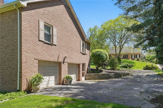 2650 Quail Hill Dr, Upper St Clair, PA 15241 - view of side of home with driveway, a garage, and brick siding