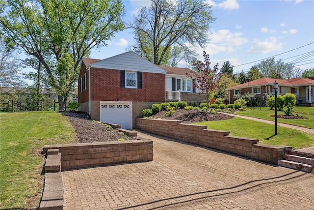 view of front of house with brick siding, decorative driveway, a front lawn, and a garage