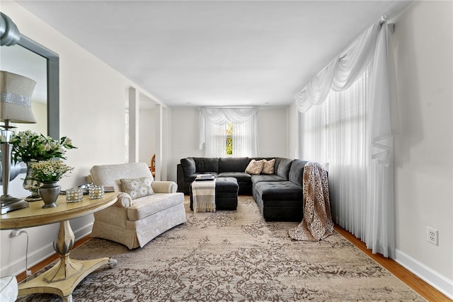 living area featuring baseboards and wood finished floors