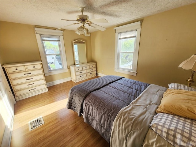 828 Butler Ave, New Castle/4Th, PA 16101 - bedroom with visible vents, a textured ceiling, light wood-style flooring, and multiple windows