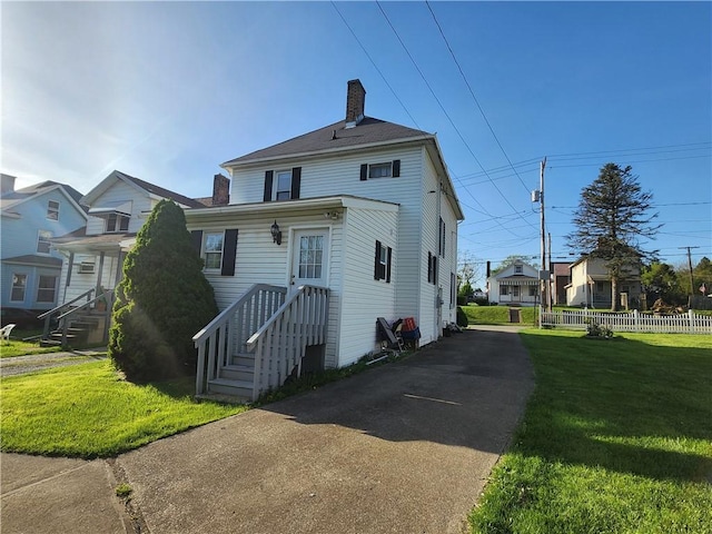 828 Butler Ave, New Castle/4Th, PA 16101 - back of house with a lawn, fence, and a chimney