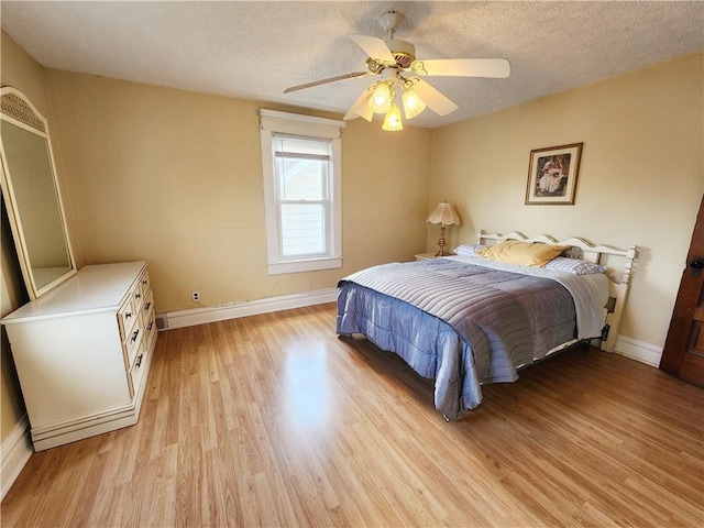 828 Butler Ave, New Castle/4Th, PA 16101 - bedroom with a textured ceiling, baseboards, ceiling fan, and light wood-style flooring