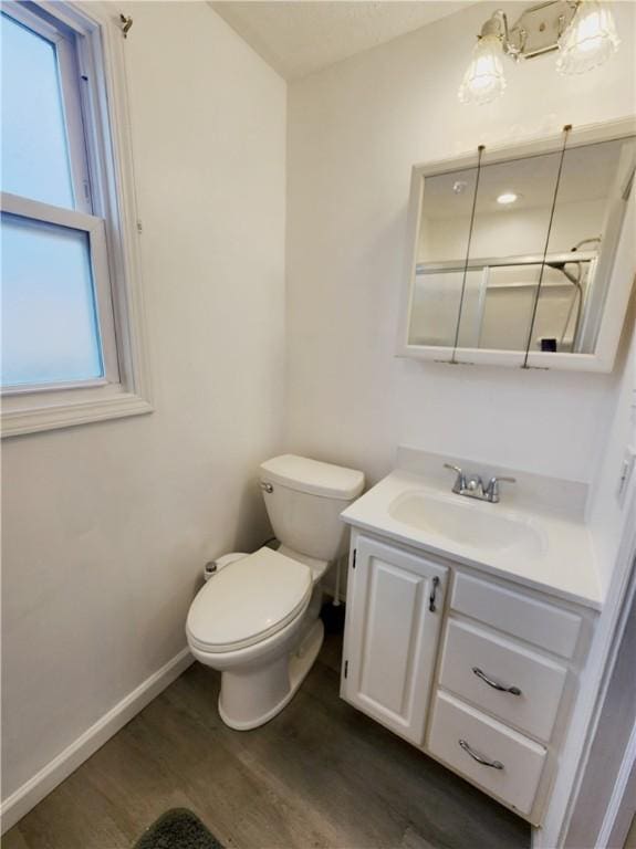 828 Butler Ave, New Castle/4Th, PA 16101 - bathroom with vanity, baseboards, wood finished floors, and toilet