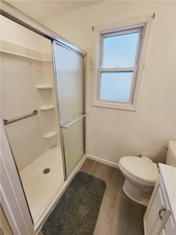 828 Butler Ave, New Castle/4Th, PA 16101 - bathroom with baseboards, a stall shower, wood finished floors, and toilet