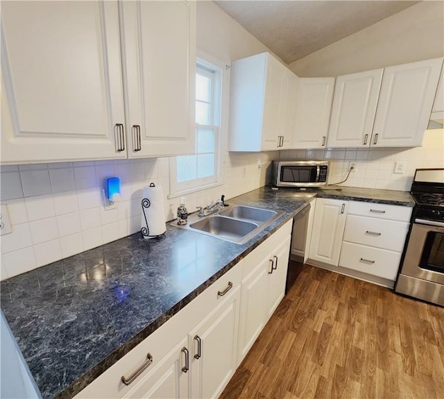 828 Butler Ave, New Castle/4Th, PA 16101 - kitchen featuring dark countertops, a sink, white cabinets, stainless steel appliances, and dark wood-type flooring