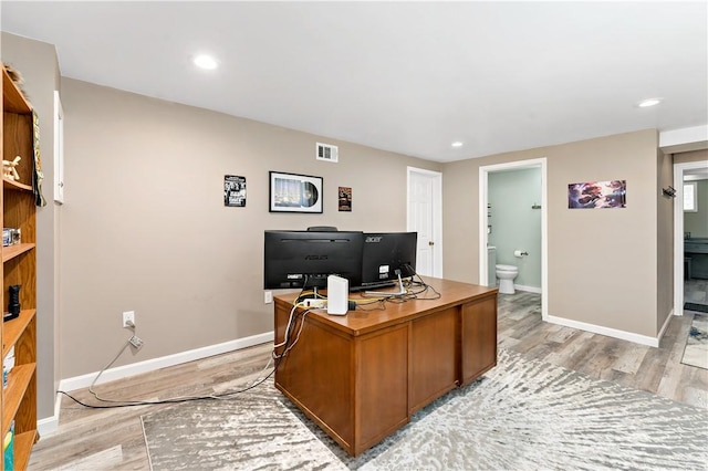 office space featuring recessed lighting, baseboards, visible vents, and light wood-style floors