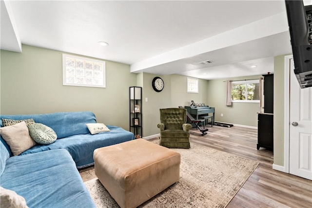 living room with recessed lighting, baseboards, and light wood finished floors