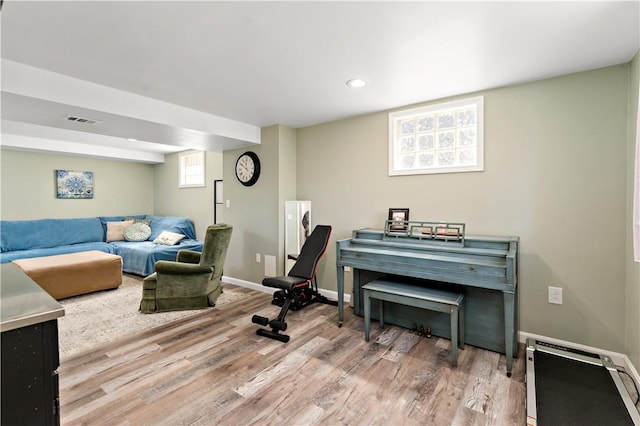 interior space with baseboards, recessed lighting, wood finished floors, and visible vents