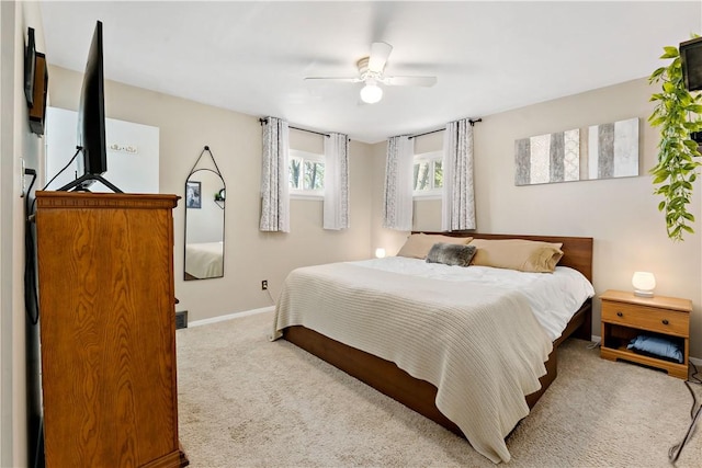 carpeted bedroom with baseboards and ceiling fan