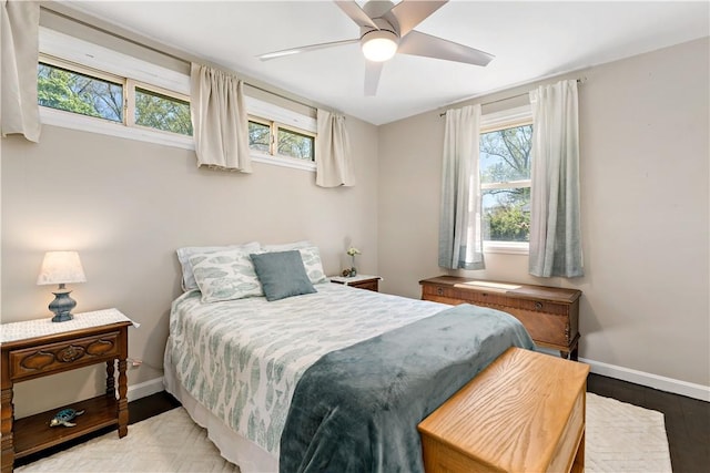 bedroom with baseboards, a ceiling fan, and wood finished floors