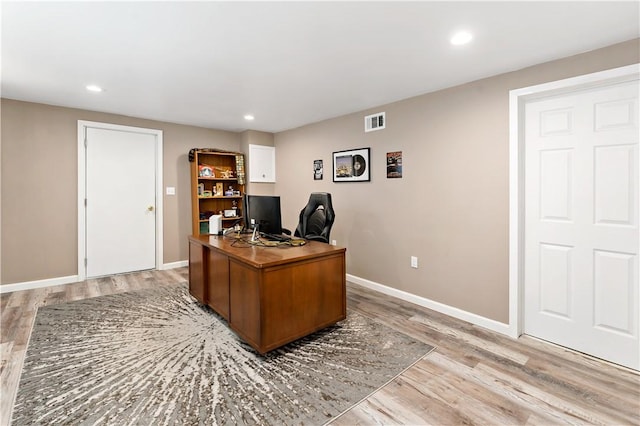 office space featuring recessed lighting, baseboards, visible vents, and light wood-type flooring