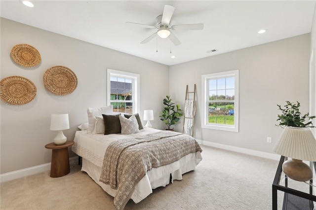 bedroom featuring baseboards, light colored carpet, and visible vents