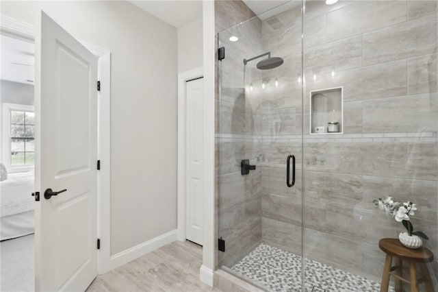 full bath featuring baseboards, ensuite bathroom, and a stall shower
