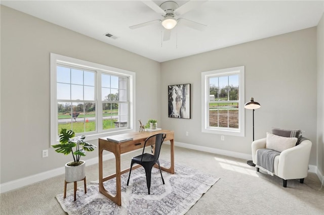 office area with visible vents, baseboards, and light colored carpet