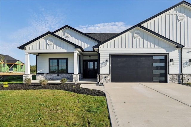 modern farmhouse style home with board and batten siding, an attached garage, driveway, and stone siding