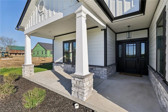 property entrance featuring board and batten siding and a porch