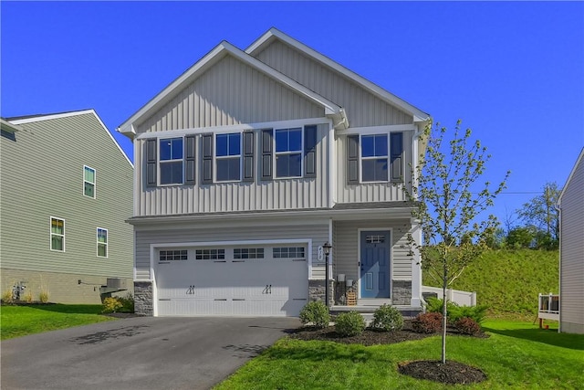 418 Fosse Ct, Lancaster Twp, PA 16037 - view of front of house with board and batten siding, an attached garage, driveway, and a front yard