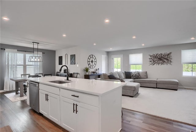 418 Fosse Ct, Lancaster Twp, PA 16037 - kitchen featuring stainless steel dishwasher, wood finished floors, an island with sink, white cabinets, and a sink