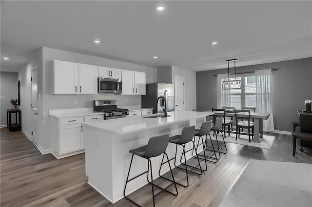 418 Fosse Ct, Lancaster Twp, PA 16037 - kitchen featuring a center island with sink, light countertops, white cabinets, a sink, and appliances with stainless steel finishes
