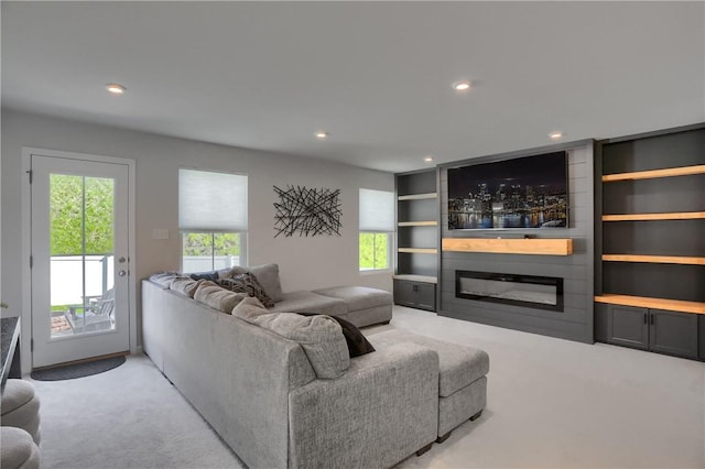 418 Fosse Ct, Lancaster Twp, PA 16037 - living room featuring built in features, a large fireplace, recessed lighting, and light colored carpet