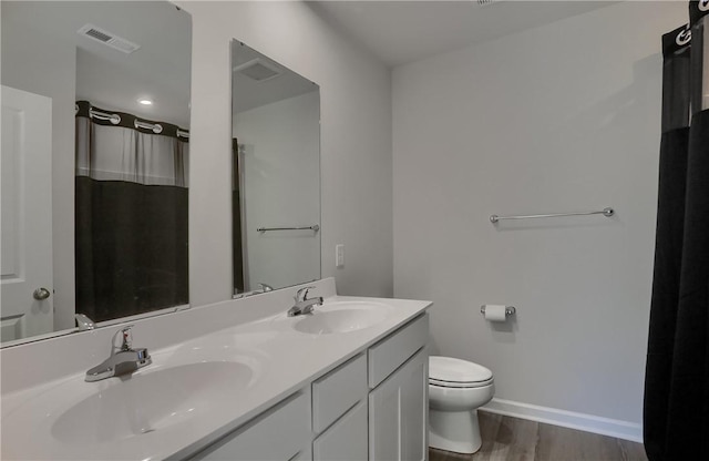 418 Fosse Ct, Lancaster Twp, PA 16037 - full bath with visible vents, a sink, wood finished floors, and toilet