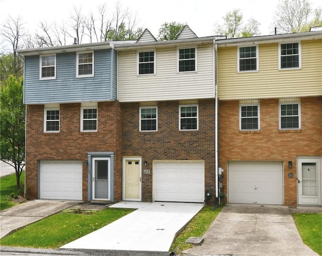 view of front facade featuring an attached garage, driveway, and brick siding