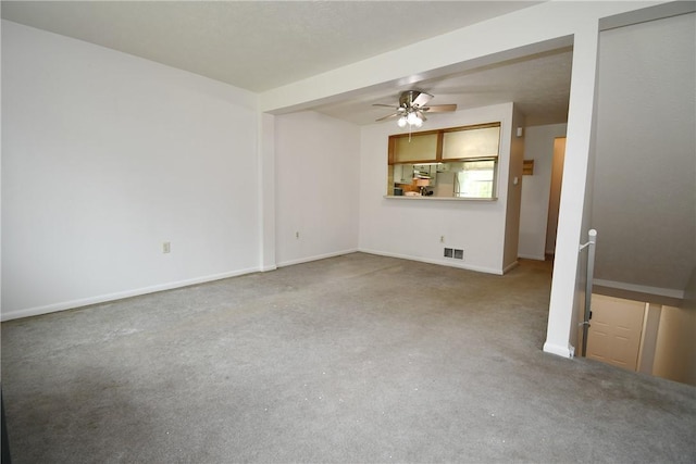unfurnished living room featuring visible vents, carpet, baseboards, and ceiling fan